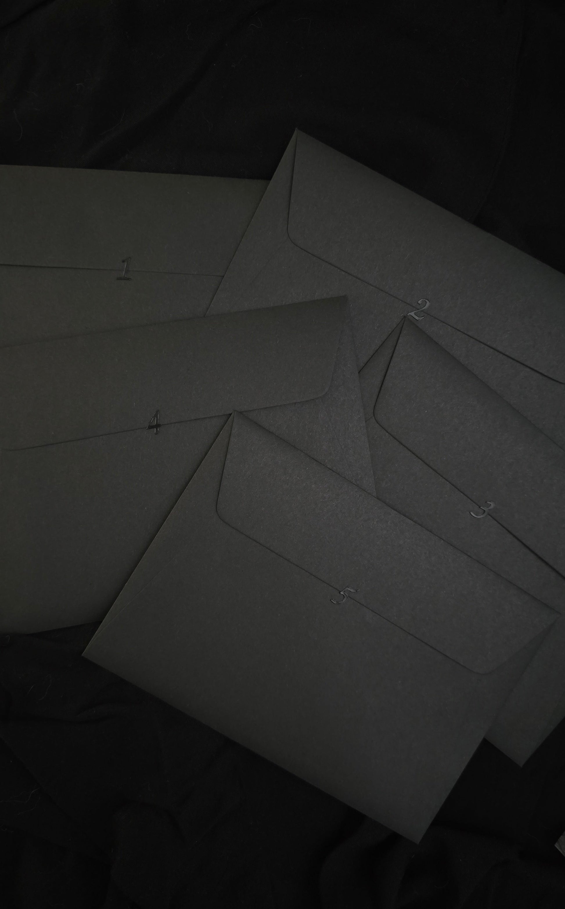Dark gray envelope on a textured black surface